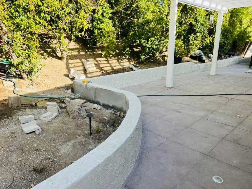 CrGM Builders exterior patio construction with new concrete curbing and landscaping.