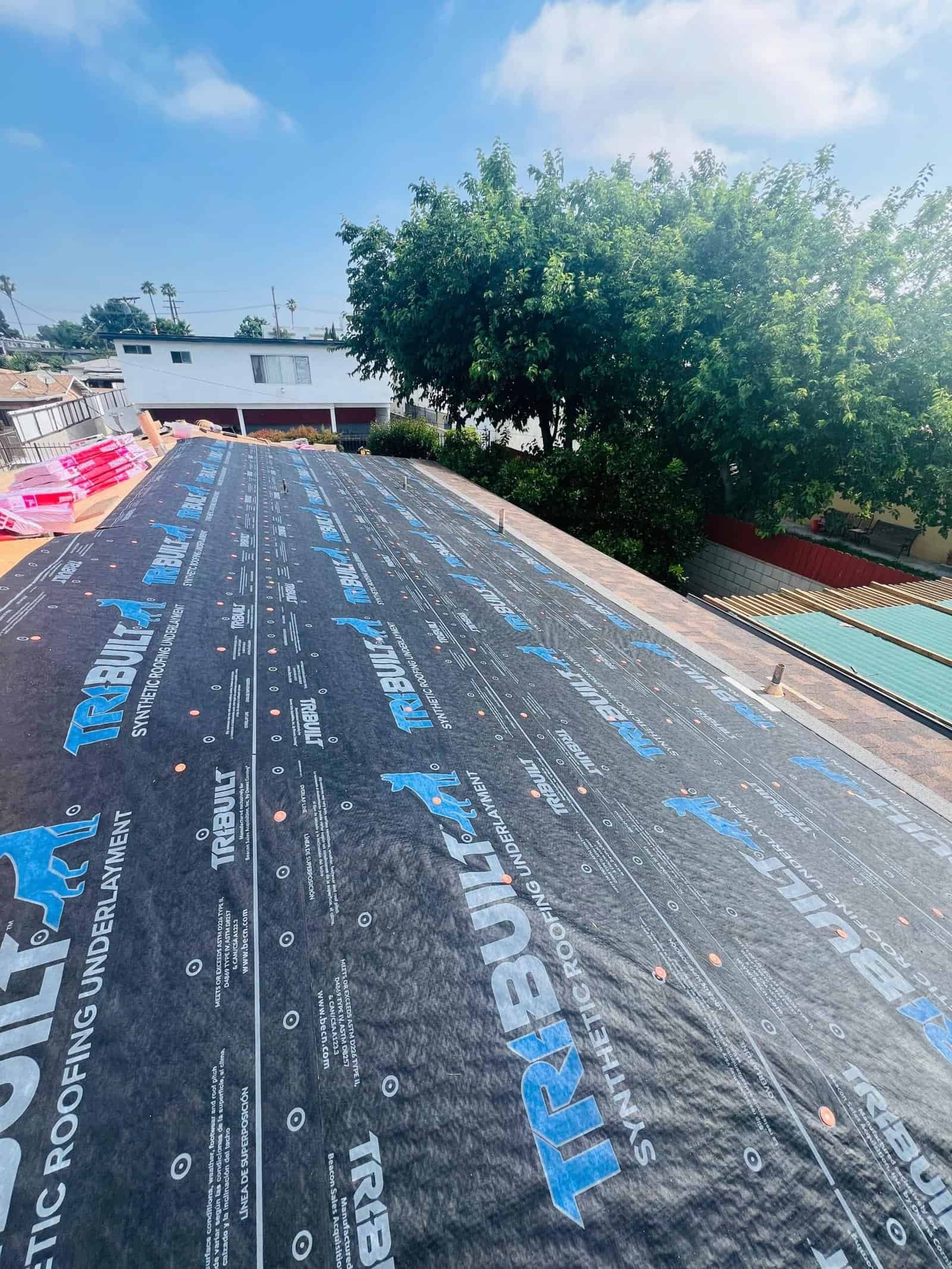 High-quality roofing underlayment being installed on a residential roof by CRGM Builders.
